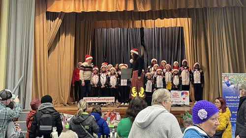 The Loving Life choir on stage at the Christmas Fair